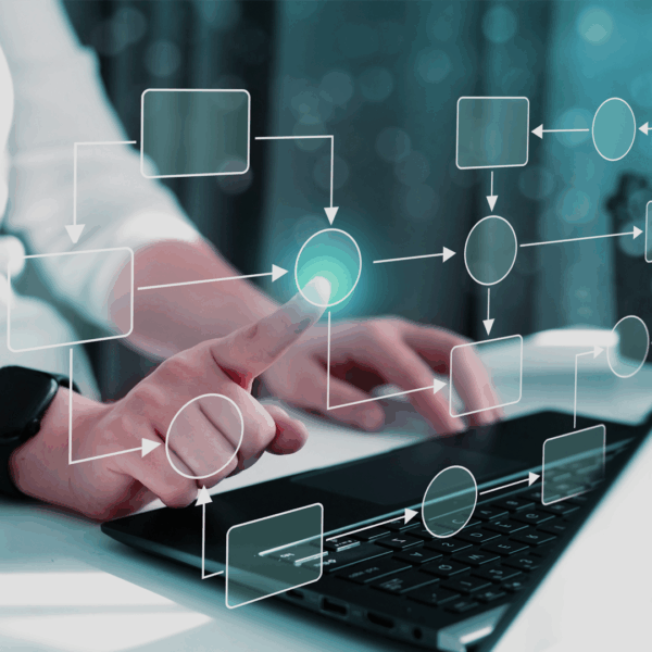 Person typing on keyboard with a digital workflow on screen.