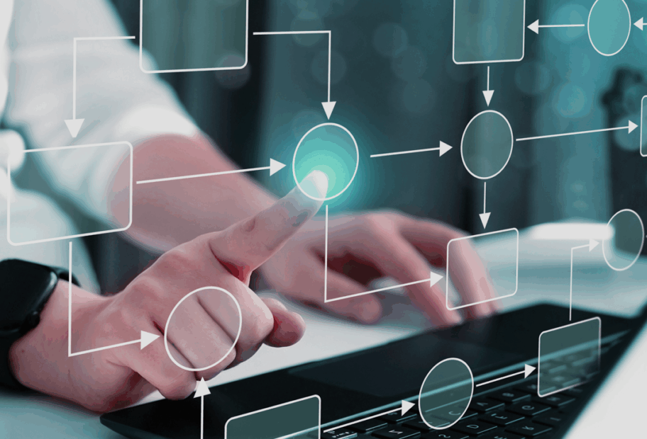 Person typing on keyboard with a digital workflow on screen.